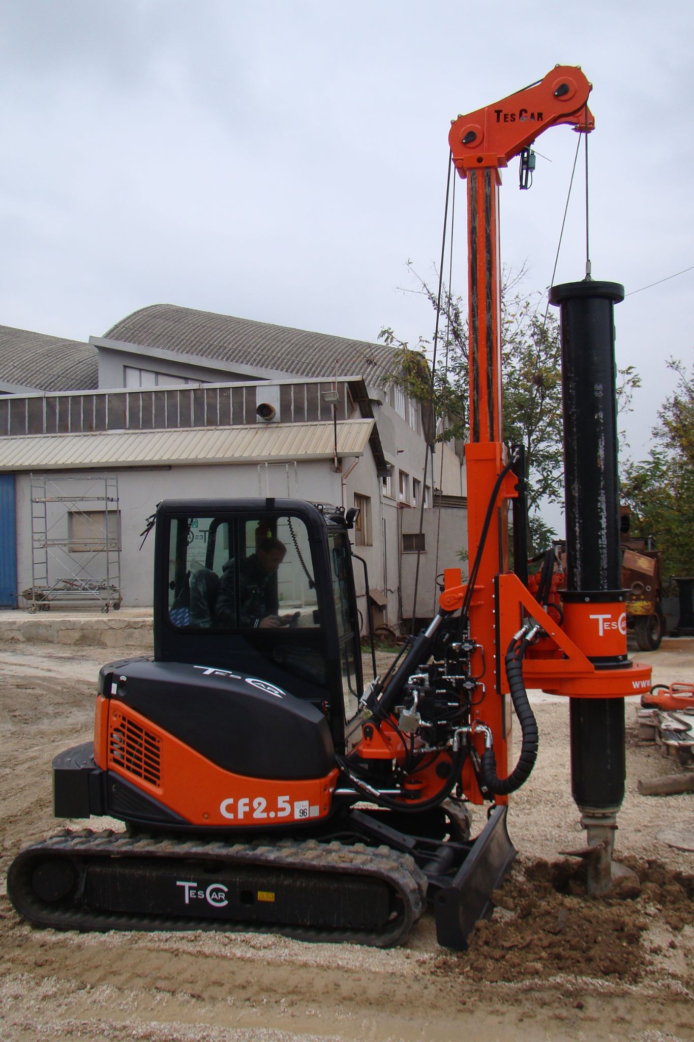 TesCar CF2.5 hydraulic piling rig in orange and black finish on a residential job site
